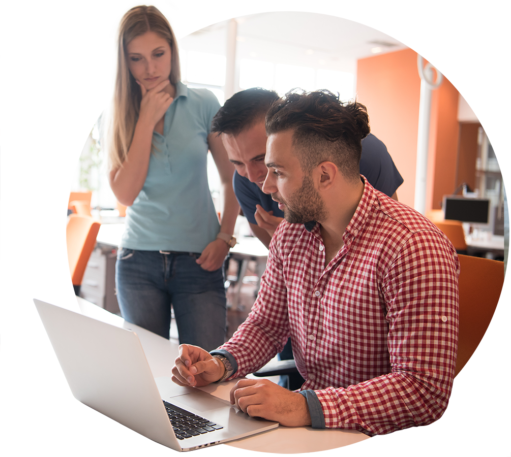 A team gathered around a laptop working through a course together